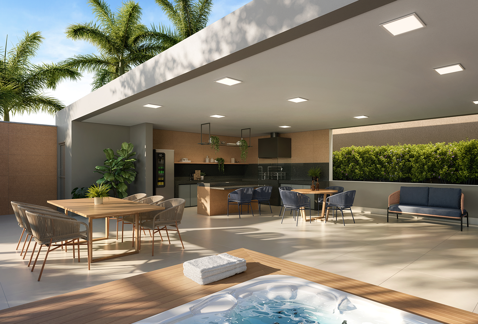 Área aberta e coberta contendo mesas, cadeiras e poltronas diversas, cozinha com churrasqueira e bancada de trabalho, e uma hidromassagem.