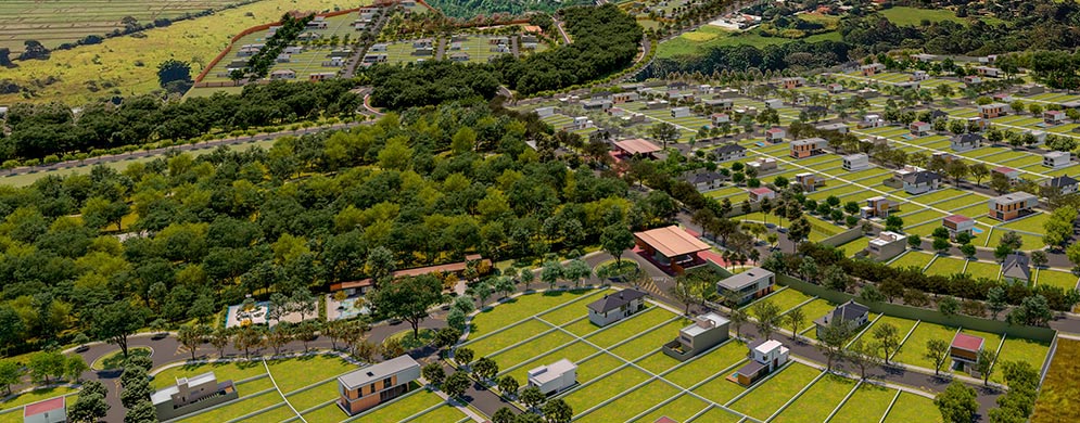 Imagem aérea que mostra lotes bem definidos em meio à natureza, com algumas casas já construídas e grande parque ao centro. 