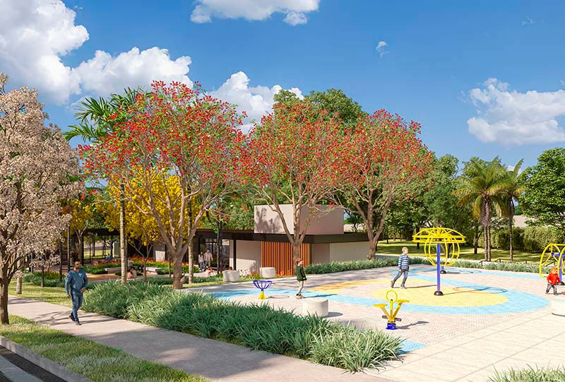 Imagem de parquinho infantil com crianças e pais se divertindo em meio a calçada arborizada e céu azul. 