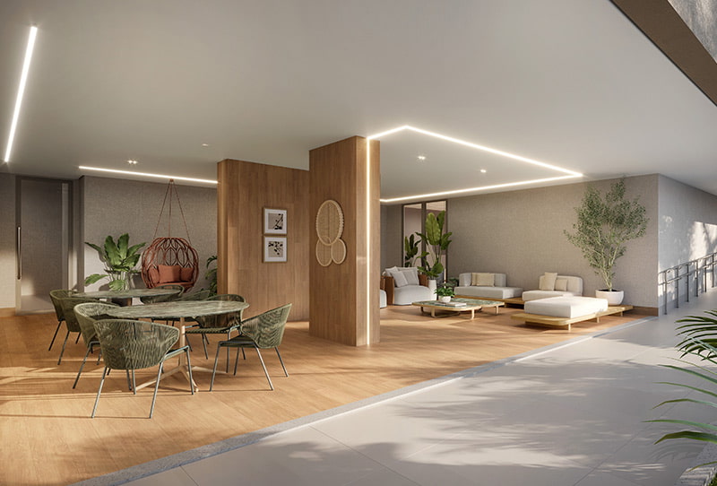 Área de convivência coberta com mesas, sofás, poltrona suspensa, plantas e acesso por rampa acessível.