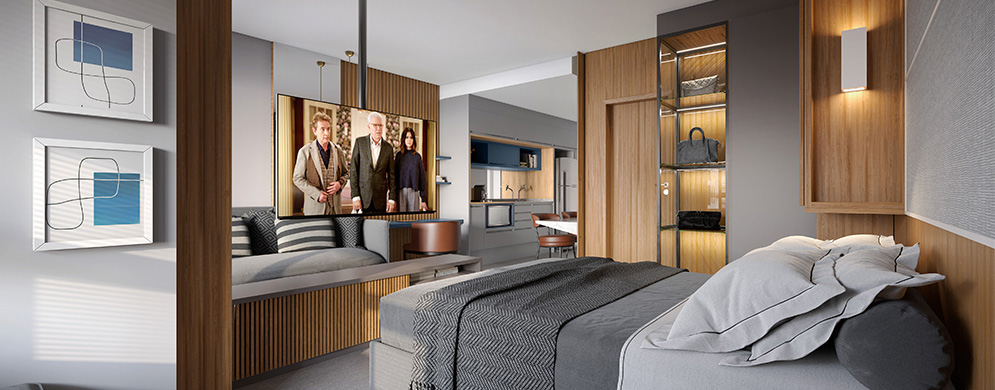 Studio integrado com cama, sofá, TV e cozinha ao fundo, em ambiente moderno com acabamentos em madeira.