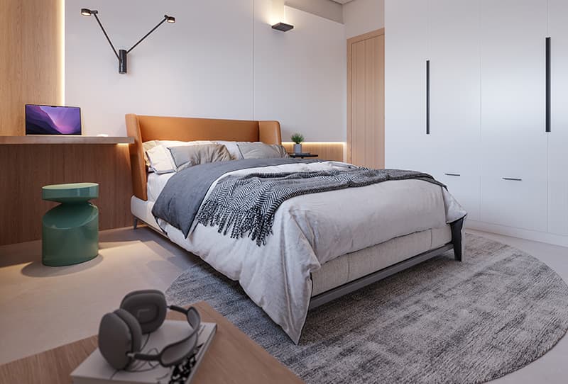 Suíte moderna com cama de casal, armário branco, bancada de trabalho em madeira e iluminação indireta.