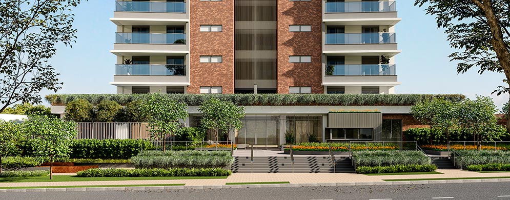 Edifício residencial com varandas, fachada em tons terrosos, entrada com escadarias e jardins arborizados.